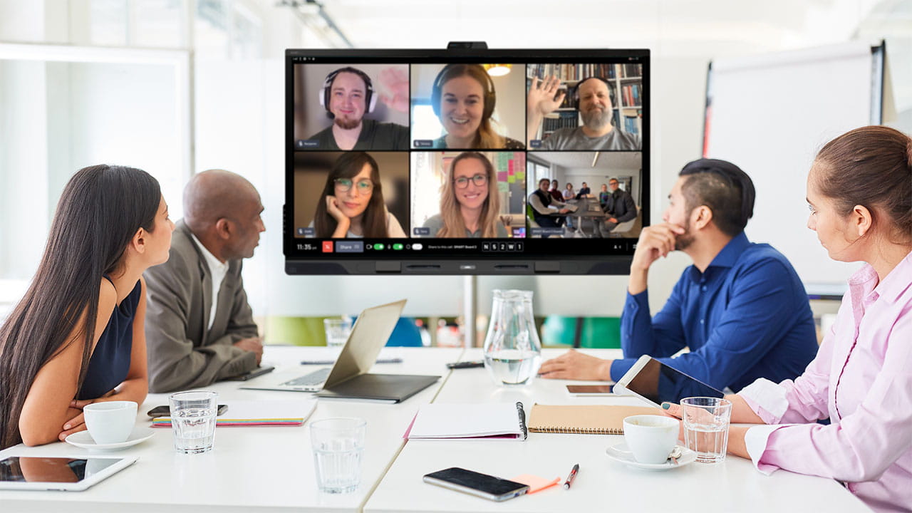 Office team participating in a remote meeting using SMART OneLaunch on a SMART Board QX Pro.